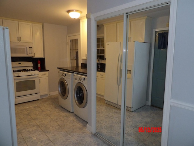 14715 Kenwood Ave, Dolton, IL 60419 - kitchen featuring white appliances, washer and dryer, white cabinetry, dark countertops, and light tile patterned floors