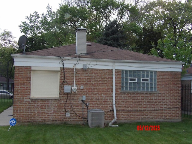 14715 Kenwood Ave, Dolton, IL 60419 - view of property exterior featuring cooling unit, brick siding, and a chimney