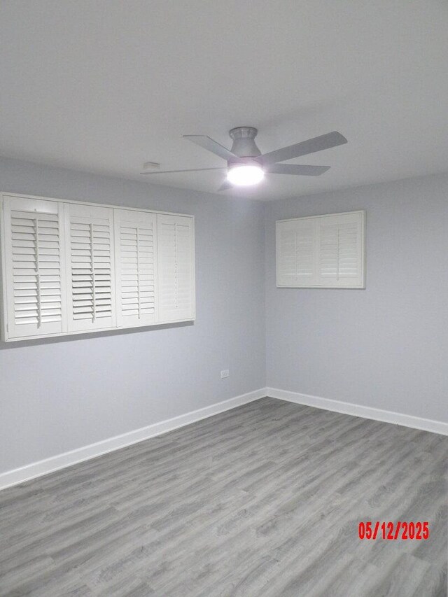14715 Kenwood Ave, Dolton, IL 60419 - spare room with wood finished floors, ceiling fan, and baseboards