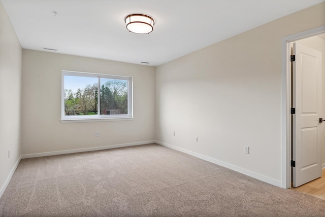 2034 W 75th Pl Unit 35, Merrillville, IN 46410 - unfurnished room with light carpet, baseboards, and a pendent fire sprinkler