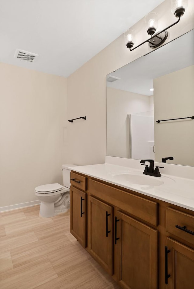 2034 W 75th Pl Unit 35, Merrillville, IN 46410 - bathroom featuring toilet, vanity, and baseboards