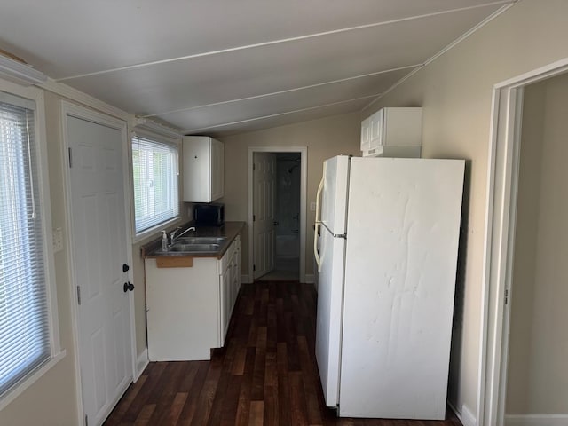 24521 W Stub Ave, Round Lake, IL 60073 - kitchen featuring freestanding refrigerator, a sink, white cabinetry, dark wood-style floors, and vaulted ceiling