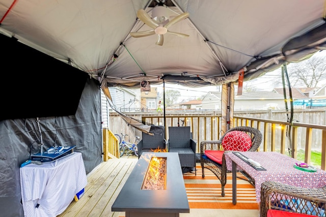 2814 W 40th St, Chicago, IL 60632 - wooden terrace with an outdoor fire pit, ceiling fan, and fence