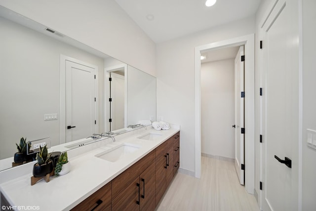 965 E 62nd St Unit 1, Chicago, IL 60637 - bathroom with double vanity, baseboards, recessed lighting, and wood finished floors