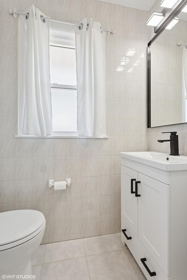 6502 Palma Ln, Morton Grove, IL 60053 - bathroom with tile walls, tile patterned flooring, vanity, and toilet