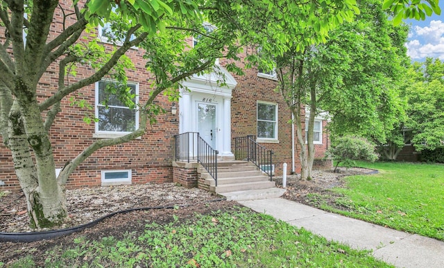 816 Arends Blvd, Rantoul, IL 61866 - view of front facade featuring a front yard and brick siding