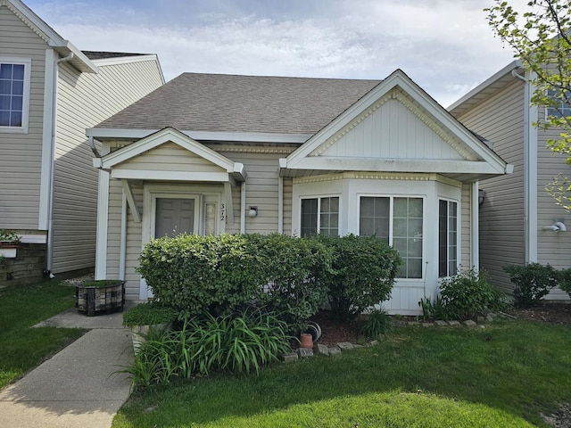 372 Windsong Ct Unit 0, Bolingbrook, IL 60440 - view of front of home featuring a shingled roof, board and batten siding, and a front lawn