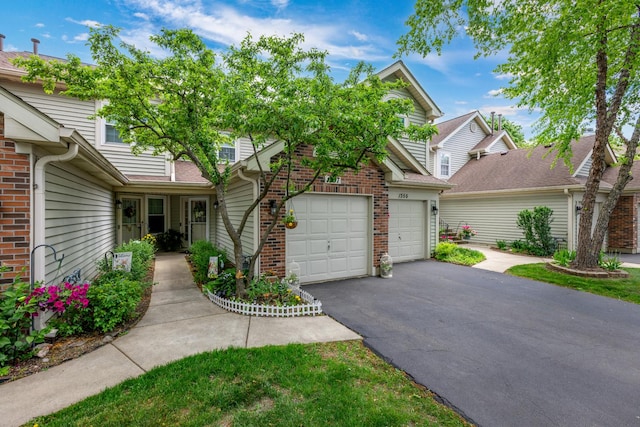 1357 Coldspring Rd, Carol Stream, IL 60188 - view of front facade with driveway, brick siding, and a garage