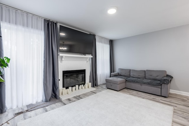 1357 Coldspring Rd, Carol Stream, IL 60188 - living room with wood finished floors, a large fireplace, and baseboards