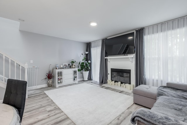 1357 Coldspring Rd, Carol Stream, IL 60188 - living room with a large fireplace, wood finished floors, stairs, and baseboards
