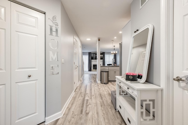 1357 Coldspring Rd, Carol Stream, IL 60188 - corridor featuring light wood-style flooring, recessed lighting, baseboards, and a sink
