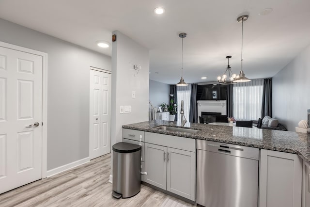 1357 Coldspring Rd, Carol Stream, IL 60188 - kitchen featuring dishwasher, a sink, open floor plan, light wood-style floors, and hanging light fixtures