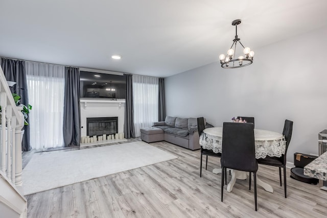 1357 Coldspring Rd, Carol Stream, IL 60188 - dining room featuring wood finished floors, healthy amount of natural light, a chandelier, and a large fireplace