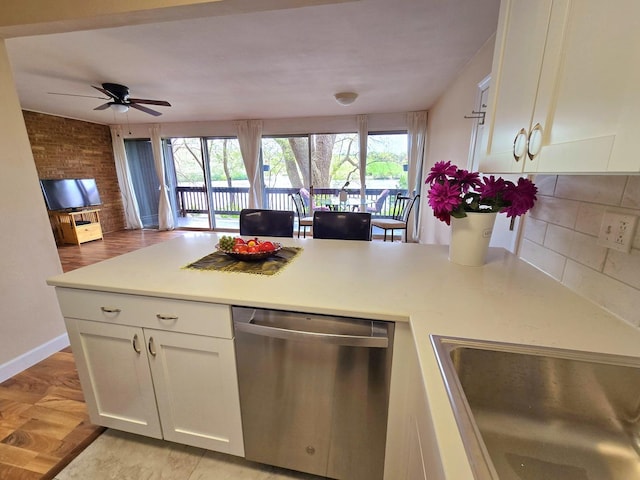 5538 E Lake Dr Unit A, Lisle, IL 60532 - kitchen featuring stainless steel dishwasher, a sink, a peninsula, white cabinets, and healthy amount of natural light