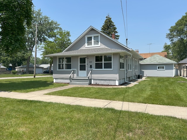 650 Enterprise St, Elgin, IL 60120 - bungalow-style house featuring a front lawn, a chimney, and central AC