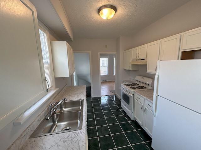 650 Enterprise St, Elgin, IL 60120 - kitchen featuring white appliances, under cabinet range hood, a sink, a textured ceiling, and white cabinetry