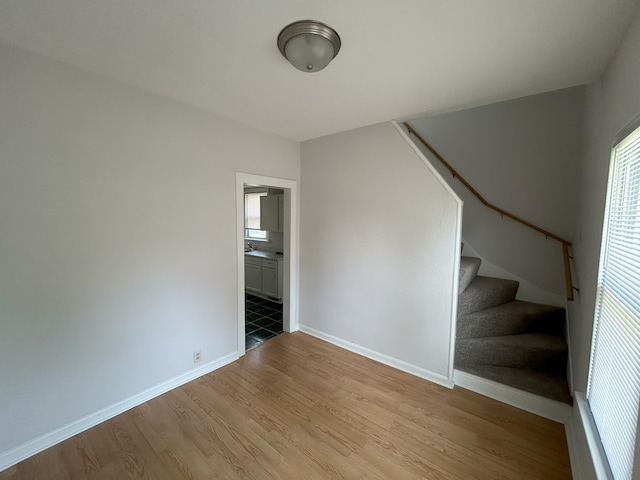 650 Enterprise St, Elgin, IL 60120 - unfurnished living room with stairway, light wood-style flooring, baseboards, and plenty of natural light