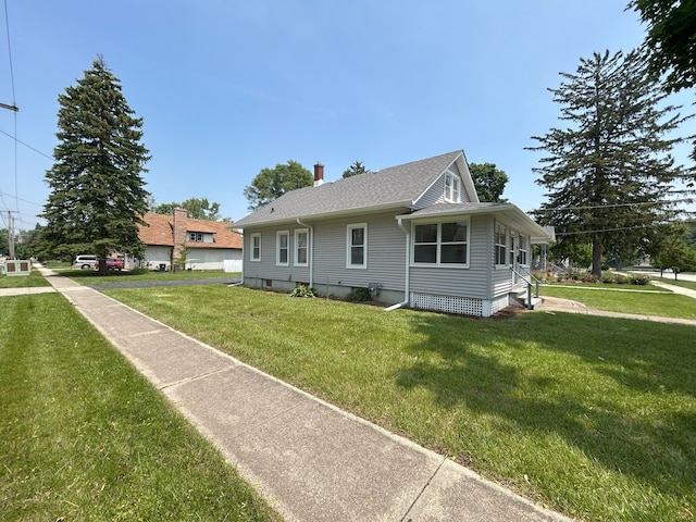 650 Enterprise St, Elgin, IL 60120 - view of side of home featuring a yard, a chimney, and roof with shingles