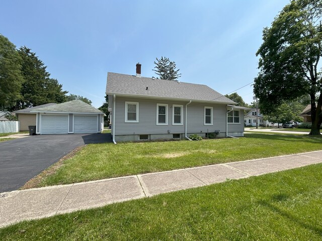 650 Enterprise St, Elgin, IL 60120 - view of front of home with a chimney, a detached garage, an outbuilding, and a front yard