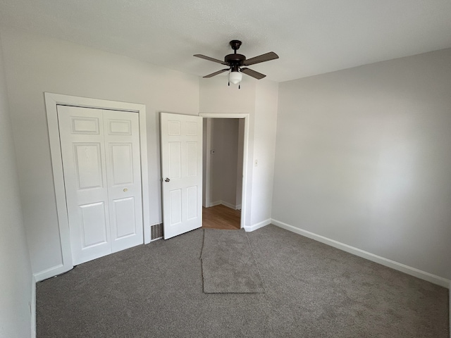 650 Enterprise St, Elgin, IL 60120 - unfurnished bedroom with dark carpet, a closet, baseboards, and a ceiling fan