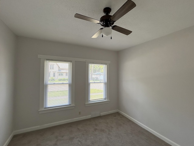 650 Enterprise St, Elgin, IL 60120 - unfurnished room featuring light carpet, baseboards, a ceiling fan, and a textured ceiling