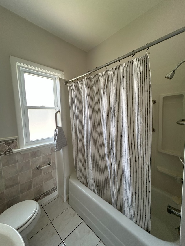 650 Enterprise St, Elgin, IL 60120 - bathroom featuring shower / bathtub combination with curtain, toilet, tile walls, and tile patterned floors