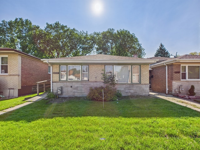 11314 S Green Bay Ave, Chicago, IL 60617 - ranch-style house with a front yard, stone siding, and brick siding