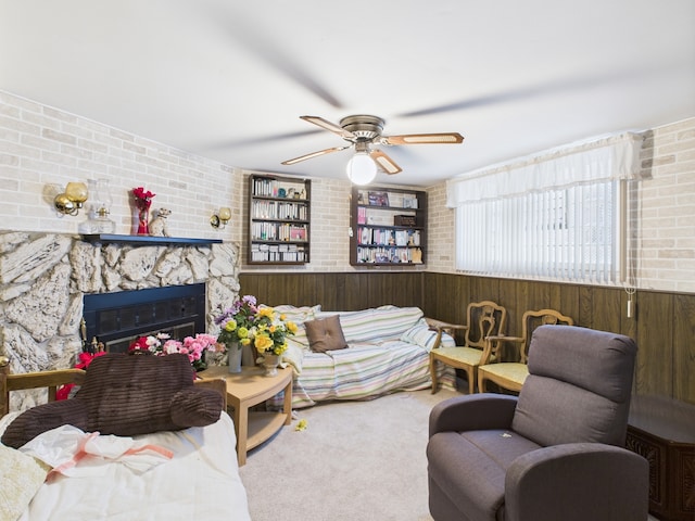 11314 S Green Bay Ave, Chicago, IL 60617 - carpeted living room with wooden walls, wainscoting, ceiling fan, a large fireplace, and brick wall