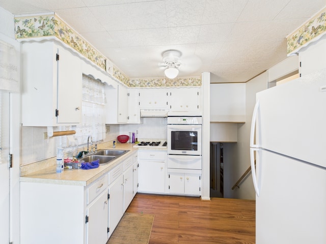 11314 S Green Bay Ave, Chicago, IL 60617 - kitchen featuring white appliances, a sink, a warming drawer, light countertops, and white cabinets