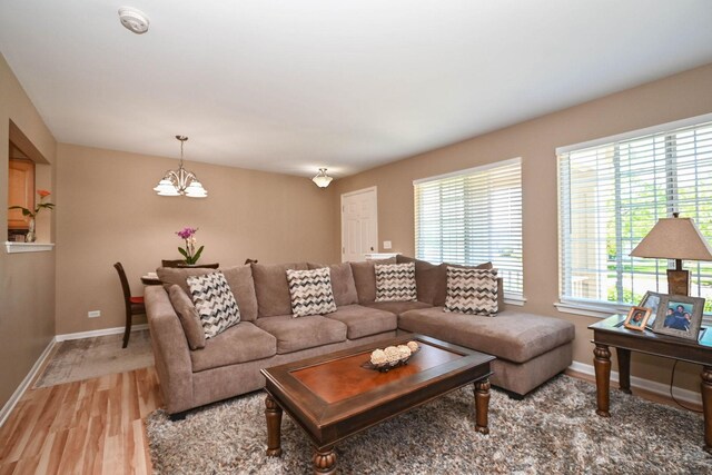 39735 N Paris Dr, Beach Park, IL 60083 - living room featuring a chandelier, baseboards, and light wood-type flooring