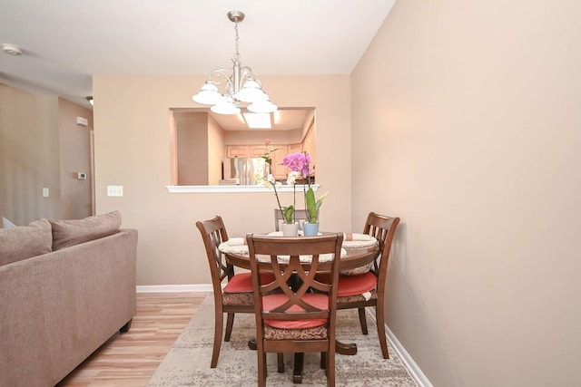 39735 N Paris Dr, Beach Park, IL 60083 - dining space featuring a chandelier, light wood-type flooring, and baseboards