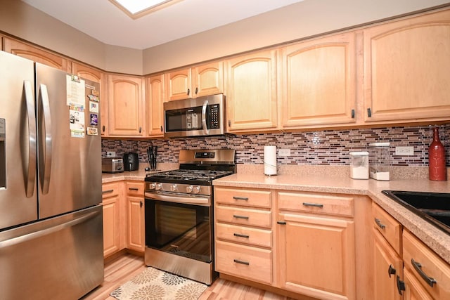 39735 N Paris Dr, Beach Park, IL 60083 - kitchen with stainless steel appliances, light brown cabinetry, decorative backsplash, and light countertops