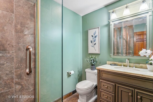 818 N Dearborn St Unit 1R, Chicago, IL 60610 - bathroom with toilet, a tile shower, vanity, and tile patterned flooring