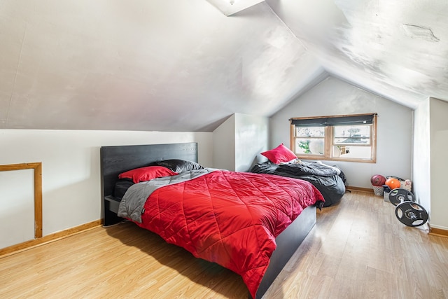 5945 W Dakin St, Chicago, IL 60634 - bedroom featuring wood finished floors, vaulted ceiling, and baseboards