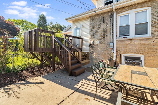 5945 W Dakin St, Chicago, IL 60634 - view of patio with outdoor dining space, a wooden deck, fence, and stairs