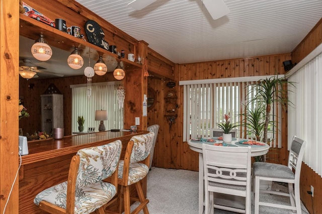 26477 Springwell St, Antioch, IL 60002 - carpeted dining area featuring ceiling fan and wooden walls