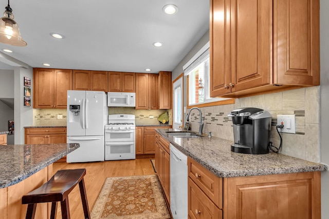 851 Munroe Cir, Des Plaines, IL 60016 - kitchen featuring white appliances, a sink, light wood-style floors, dark stone countertops, and brown cabinetry