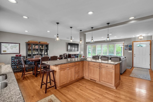851 Munroe Cir, Des Plaines, IL 60016 - kitchen featuring light wood-type flooring, a kitchen bar, open floor plan, recessed lighting, and hanging light fixtures