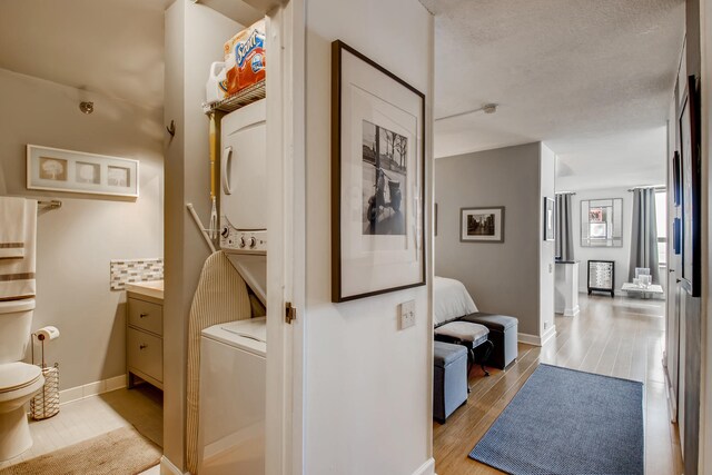 474 N Lake Shore Dr Unit 2012, Chicago, IL 60611 - laundry area featuring stacked washer / dryer, light wood-style flooring, and baseboards