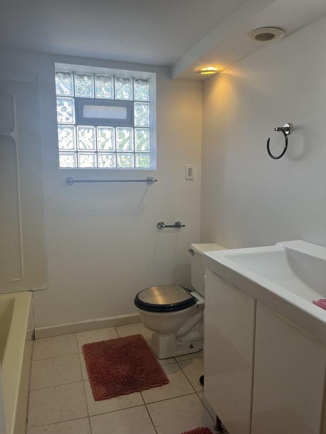 2720 N Budd St, River Grove, IL 60171 - bathroom with vanity, toilet, tile patterned flooring, and baseboards