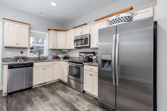 7 Pelican, Ottawa, IL 61350 - kitchen with stainless steel appliances, a sink, dark countertops, dark wood-style floors, and recessed lighting