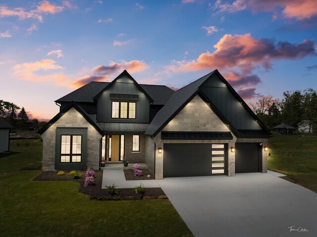 8740 Adria Ct, Orland Park, IL 60462 - view of front of house featuring stone siding, concrete driveway, an attached garage, a standing seam roof, and a yard