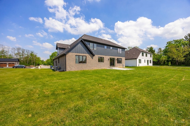8740 Adria Ct, Orland Park, IL 60462 - back of house with brick siding, board and batten siding, a lawn, a patio, and a shingled roof