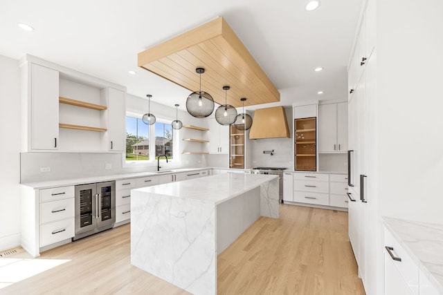 8740 Adria Ct, Orland Park, IL 60462 - kitchen with open shelves, wine cooler, custom range hood, light wood-style flooring, and recessed lighting