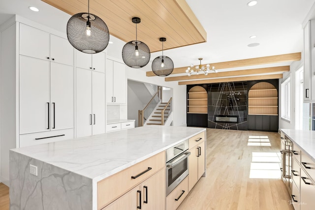 8740 Adria Ct, Orland Park, IL 60462 - kitchen with light wood-type flooring, light stone countertops, pendant lighting, recessed lighting, and open floor plan