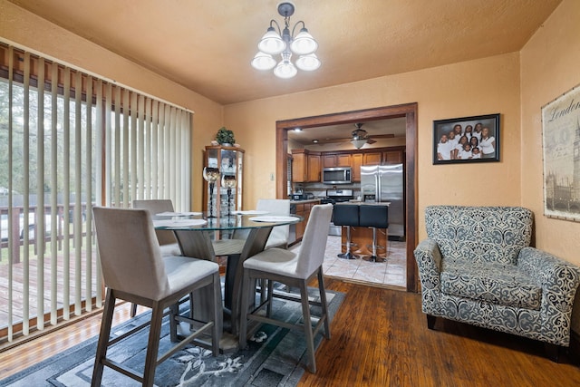 1341 Englewood Ave, Joliet, IL 60432 - dining area with wood-type flooring, a chandelier, ceiling fan, and a textured wall