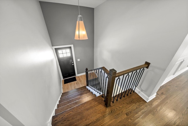 3412 Sunnyside Ave, Brookfield, IL 60513 - staircase with wood finished floors, baseboards, and a towering ceiling
