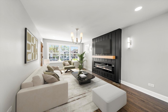 3412 Sunnyside Ave, Brookfield, IL 60513 - living room featuring a chandelier, baseboards, wood finished floors, recessed lighting, and a large fireplace