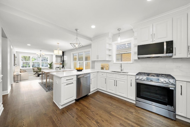 3412 Sunnyside Ave, Brookfield, IL 60513 - kitchen featuring appliances with stainless steel finishes, a sink, a peninsula, backsplash, and open shelves