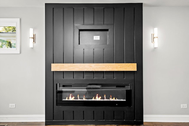 3412 Sunnyside Ave, Brookfield, IL 60513 - detailed view of baseboards, wood finished floors, and a fireplace